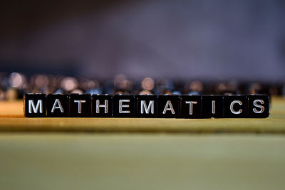 Close-up of information sign on table