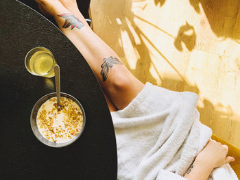 High angle view of woman holding coffee cup