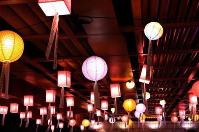 Low angle view of illuminated lanterns hanging at night