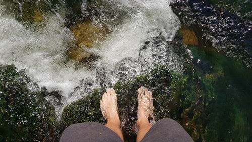 Low section of man splashing water