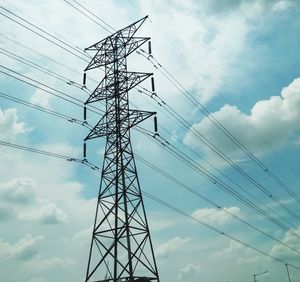 Low angle view of electricity pylon against sky