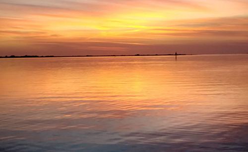 Scenic view of sea against romantic sky at sunset