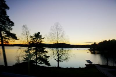 Scenic view of lake against sky at sunset