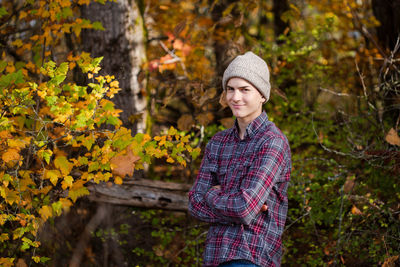 Portrait of smiling man standing against plants