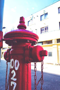 Close-up of fire hydrant against buildings in city