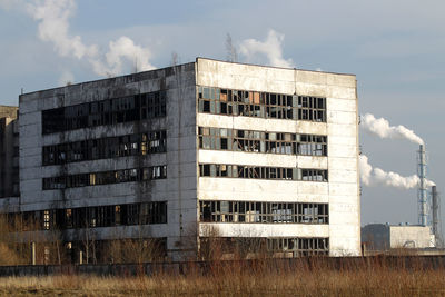 Low angle view of abandoned building against sky