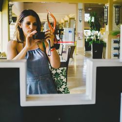 Young woman using mobile phone at home