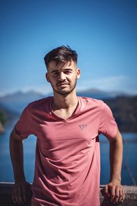 Young man standing against sky