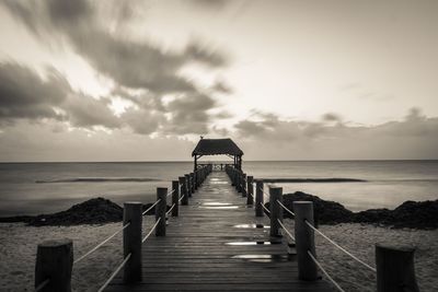 Pier over sea against sky