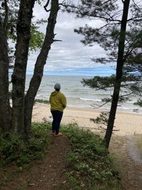 Rear view of woman standing on field