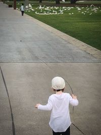 Rear view of a boy standing on grassland