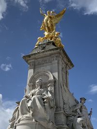 Low angle view of statue against cloudy sky