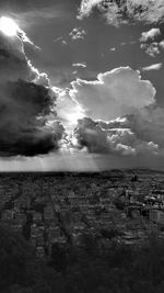 View of cityscape against cloudy sky