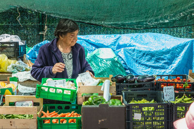 Portrait of man working at market stall