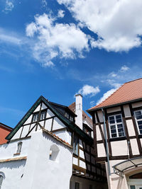 Frame houses against blue sky and clouds 