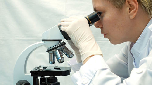 Scientist looking in microscope