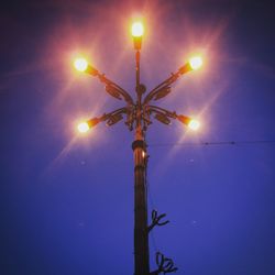 Low angle view of illuminated lights at night