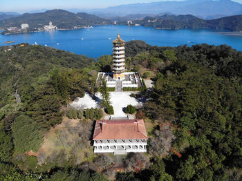 High angle view of building by sea against mountains