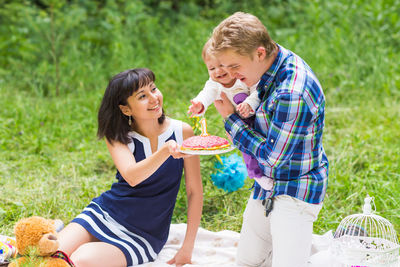 Man and woman holding ice cream outdoors