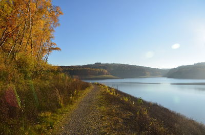 Scenic view of lake against clear sky during autumn