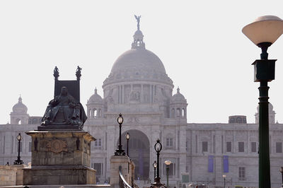 Buildings in city against clear sky