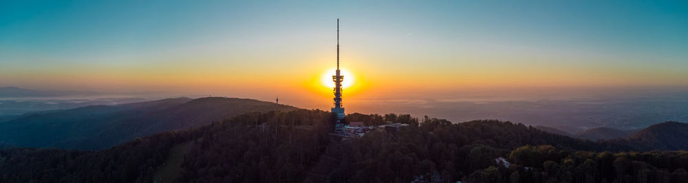 Scenic view of mountains against clear sky during sunset