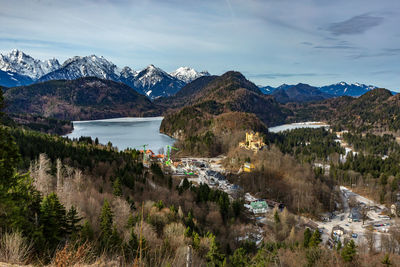 Scenic view of river and mountains against sky