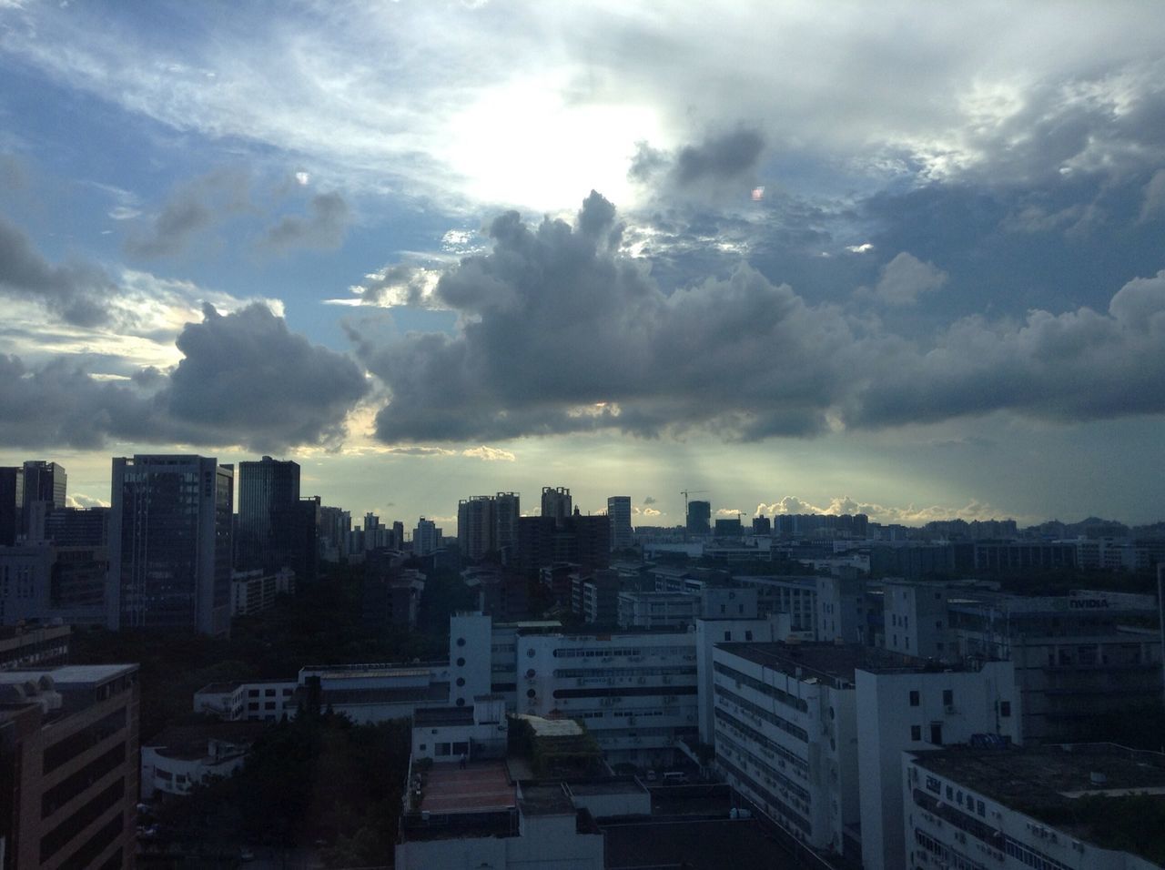 building exterior, city, architecture, built structure, cityscape, sky, cloud - sky, crowded, residential district, residential building, cloudy, residential structure, skyscraper, cloud, high angle view, city life, weather, dusk, sunset, urban skyline