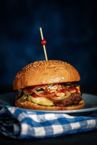 Close-up of burger against black background