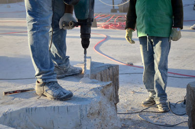 Low section of artists making stone sculpture