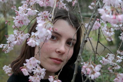 Close-up of woman with pink flowers