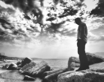 Man looking at sea against sky