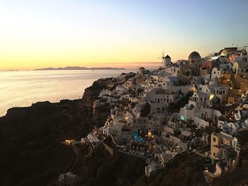 High angle view of townscape by sea against sky