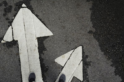 High angle view of arrow sign on road