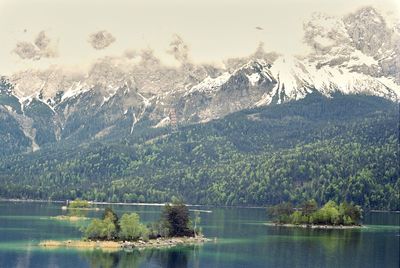 Scenic view of lake by snowcapped mountains