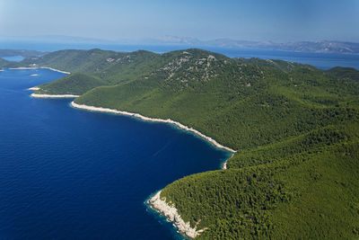 High angle view of sea and mountains against sky