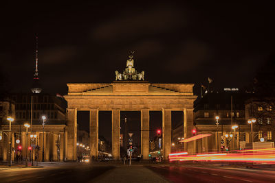 Statue in city at night
