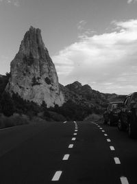 Road by mountain against sky