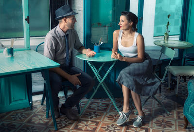 Couple sitting at table in cafe
