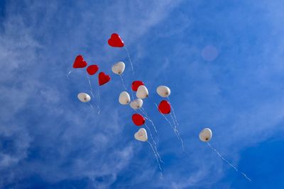 Low angle view of balloons against sky