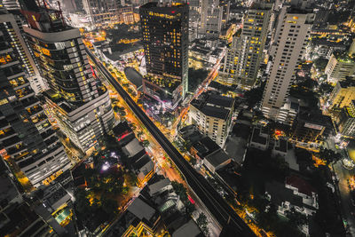 High angle view of city lit up at night