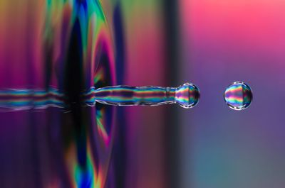 Close-up of bubbles against rainbow in water