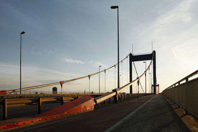 View of suspension bridge against cloudy sky