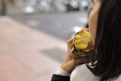 Midsection of woman holding ice cream