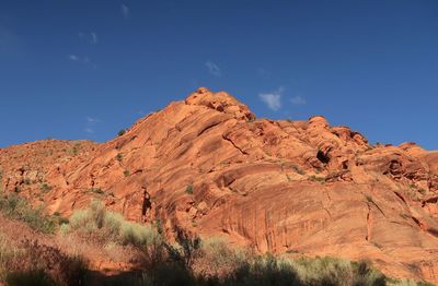 Low angle view of rock formations against blue sky