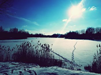 Scenic view of frozen lake against sky during winter