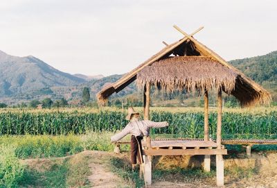 Traditional windmill on field against sky