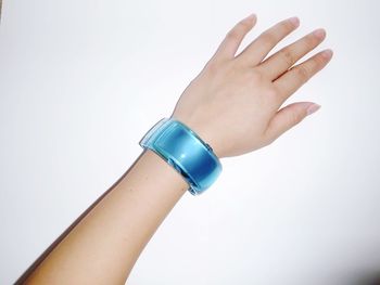 Close-up of hand holding over white background