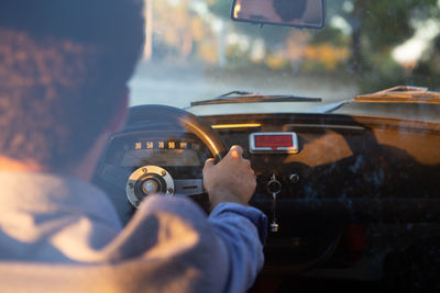 Rear view of man driving car