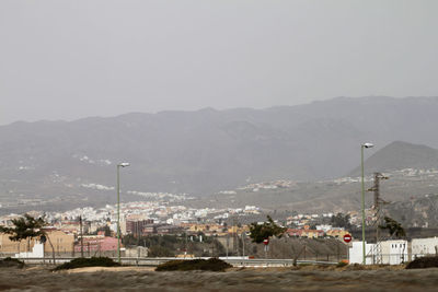 View of landscape with mountain range in background